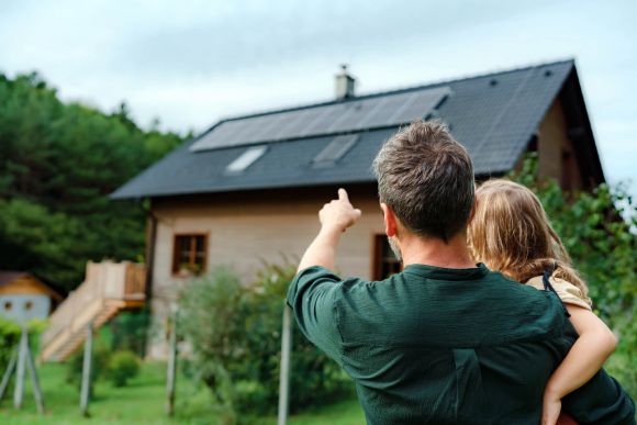 Vorteile, Haus mit Photovoltaikanlage und Vater mit Kind